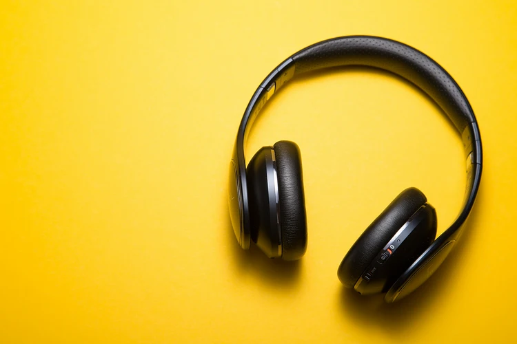 Black headphones on a yellow background