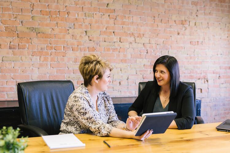 Two women sitting and talking