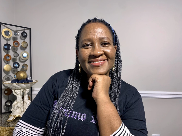 Ijeoma sitting and smiling