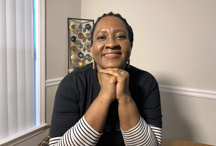 Sitting with face on knuckles